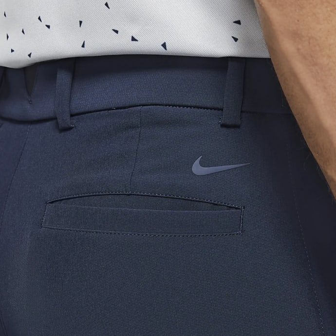 Nike navy blue athletic pants with white swoosh logo.