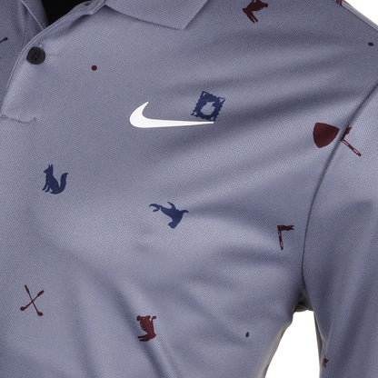 Nike polo shirt with animal and golf club prints, gray background.