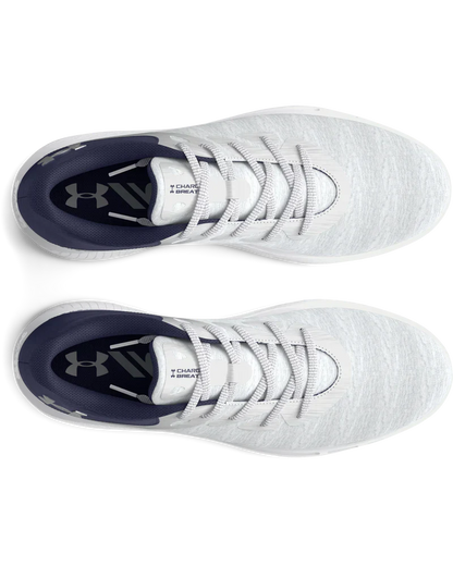 White under armour baseball cleat with black accents and laces.